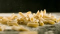 Fresh Penne Rigate pasta with flour on kitchen table Royalty Free Stock Photo