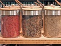 Colorful fresh peppercorns, various spices and colours, close up, jars, stockpot, ingredients