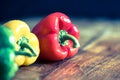 Fresh peppers red, green, yellow on wooden board