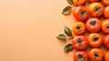 Fresh persimmon fruit with leaves on orange background, copy space