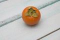 Fresh persimmon on a wooden background fruit