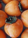 Fresh persimmons on the table. Royalty Free Stock Photo