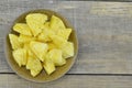 Fresh pieapple cut slices in brown plate on wooden table Royalty Free Stock Photo