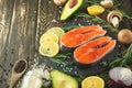 Fresh pieces of salmon steak, trout, salmon, pink salmon. With ingredients vegetables, avocado, rosemary and broccoli. Healthy and Royalty Free Stock Photo