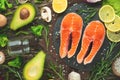 Fresh pieces of salmon steak, trout, salmon, pink salmon. With ingredients vegetables, avocado, rosemary and broccoli. Healthy and Royalty Free Stock Photo