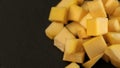 Fresh pineapple cube slices on black background. Pineapple chunks close up