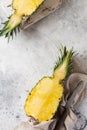 Fresh pineapple cut in two on gray concrete old background. Summer concept. Creative flat lay with copy space. Royalty Free Stock Photo