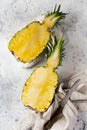 Fresh pineapple cut in two on gray concrete old background. Summer concept. Creative flat lay with copy space. Royalty Free Stock Photo