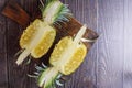 Fresh pineapple fruit cut in half on a wooden table Royalty Free Stock Photo