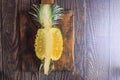 Fresh pineapple fruit cut in half on a wooden table Royalty Free Stock Photo