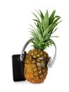 Fresh pineapple with headphones, smart phone and glasses