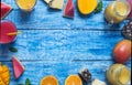 Fresh pineapple, mango and watermelon cocktail in two glasses with fruits on a blue wooden rustic background, copy space Royalty Free Stock Photo