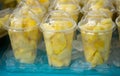 Fresh pineapple pieces salad in plastic transparent cups