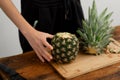 Fresh pineapple preparation on a wooden cutting board Royalty Free Stock Photo