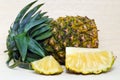 Fresh pineapple with slices on wood