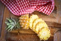 fresh pineapple tropical fruits summer, pineapple slice on plate for food fruit ripe pineapple on wooden background - top view Royalty Free Stock Photo