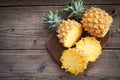 fresh pineapple tropical fruits summer, pineapple slice on plate for food fruit ripe pineapple on wooden background - top view Royalty Free Stock Photo
