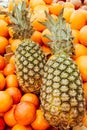 Fresh Pineapples and Oranges for Sale on Market Stall