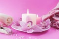 Fresh pink orchid flowers, burning candles