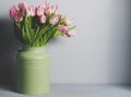 Fresh pink tulip flowers bouquet on shelf in front of stone wall. View with copy space Royalty Free Stock Photo