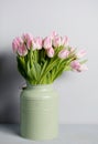Fresh pink tulip flowers bouquet on shelf in front of stone wall. View with copy space Royalty Free Stock Photo