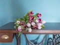 Fresh pink tulip flowers bouquet on shelf in front of stone wall. View with copy space and shadow Royalty Free Stock Photo