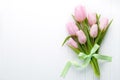 Fresh pink tulip flowers bouquet on shelf in front of wooden wall. Royalty Free Stock Photo