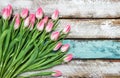 Fresh pink tulips water drops wooden background