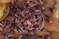 Fresh pistachios in copper bowl on wooden rustic background, wonderful peanut composition for healthy and dietary nutrition.