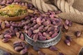 Fresh pistachios in copper bowl on wooden rustic background, wonderful peanut composition for healthy and dietary nutrition.