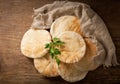 Fresh pita bread on a wooden table, top view