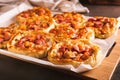 Fresh pizza pot pies with tomatoes, cheese and sausages on a wooden board Royalty Free Stock Photo