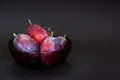 Fresh plum. Autumn harvest. Ripe purple plums in glass bowl on dark background. Concept: seasonal fruits, healthy food. Close up. Royalty Free Stock Photo