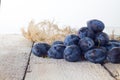 Fresh plums in basket on white background. Royalty Free Stock Photo