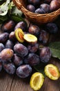 Fresh plums on brown wooden background Royalty Free Stock Photo