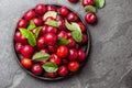 Fresh plums with leaves on black plate. Slate background Royalty Free Stock Photo