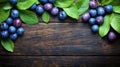 Fresh plums and leaves on rustic wooden table Royalty Free Stock Photo