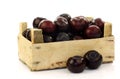 Fresh plums in a wooden crate