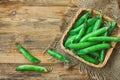 Fresh pods of green peas in basket, napkin burlap Royalty Free Stock Photo
