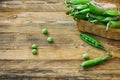 Fresh pods of sweet green peas in basket on table Royalty Free Stock Photo