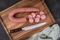 Slicing Kielbasa into bites for cooking Royalty Free Stock Photo