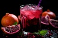 Fresh pomegranate fruit, glass of juice, scattered seeds, and blossoms on the table