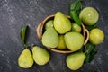 Fresh pomelo, pummelo, grapefruit, shaddock in bamboo basket with leaf on dark black slate background. Seasonal fruit concept. Top