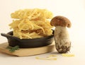 Fresh porcini mushroom and raw pasta.