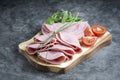 Fresh pork ham slices on cutting board over dark background Royalty Free Stock Photo