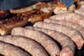 Fresh pork sausages on the grill, prepared for baking, close-up Royalty Free Stock Photo