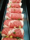 Fresh pork slice for grill serving on black tray top with chop spring onion which focus-on-foreground blur background