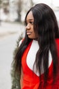 Fresh portrait beautiful young African woman with long hair with clean skin with sexy lips in stylish red elegant clothes outdoors Royalty Free Stock Photo