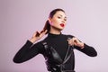Fresh portrait beautiful young woman with clean skin with sexy red lips in fashionable black leather clothes with trendy hairstyle Royalty Free Stock Photo