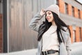 Fresh portrait charming joyful young woman with beautiful smile with long hair in fashionable youth clothes on street in the city Royalty Free Stock Photo